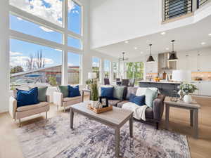 Living room with light hardwood / wood-style floors and a high ceiling