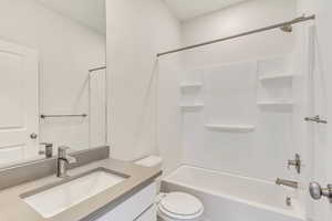 Full bathroom with washtub / shower combination, vanity, and toilet