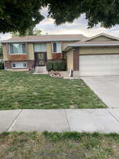 Single story home with a front lawn and a garage