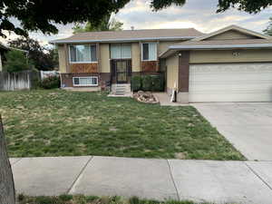 View of front of home featuring a garage and a front lawn