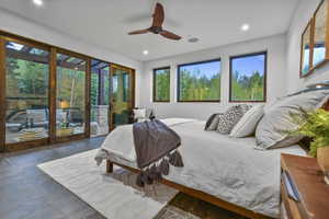 Tiled bedroom with ceiling fan and access to outside