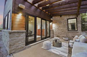 Patio terrace at dusk with a pergola and french doors