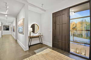 Entrance foyer featuring tile flooring and track lighting