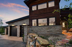 Property exterior at dusk featuring a garage