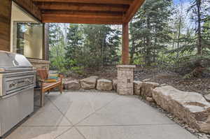 View of patio with an outdoor kitchen and area for grilling