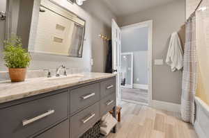 Bathroom featuring hardwood / wood-style flooring and vanity