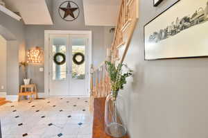 Foyer with tile flooring and french doors