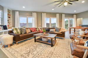 Living room featuring tile flooring and ceiling fan