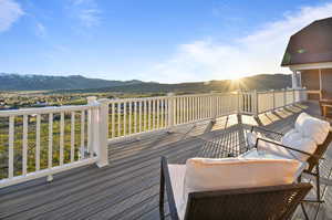 Wooden deck featuring an outdoor living space and a mountain view