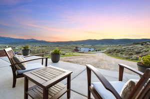 Patio terrace at dusk with a mountain view