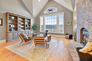 Living room featuring plenty of natural light, light hardwood / wood-style flooring, and a fireplace