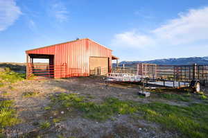 View of outdoor structure featuring a mountain view and a rural view