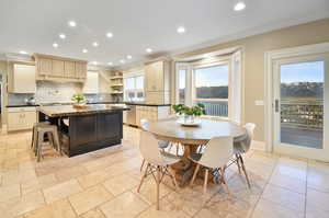 Tiled dining area with sink and crown molding