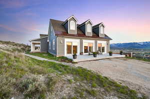 View of front of property featuring a mountain view and a patio