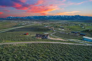 Aerial view at dusk featuring a mountain view and a rural view