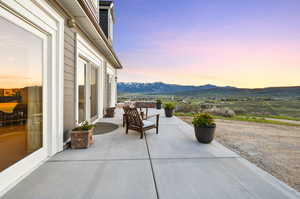 Patio terrace at dusk with a mountain view