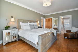 Bedroom featuring crown molding and hardwood / wood-style flooring