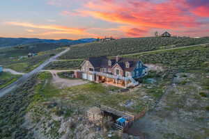 Aerial view at dusk featuring a rural view and a mountain view