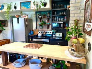 Custom butcher block counter. Original exposed brick.