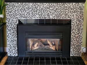 Gas fireplace with modern penny tile surround.