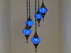 Boho chandelier in stairwell to second floor.