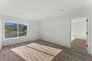 Unfurnished room featuring hardwood / wood-style floors