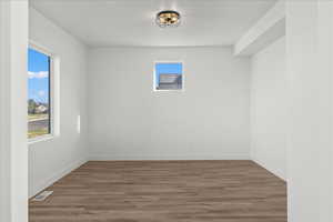 Unfurnished room with hardwood / wood-style floors