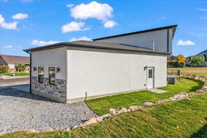 View of home's exterior featuring central AC and a yard