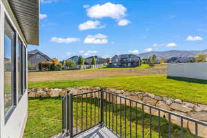 View of yard featuring a balcony and a mountain view