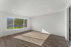 Empty room with dark hardwood / wood-style floors