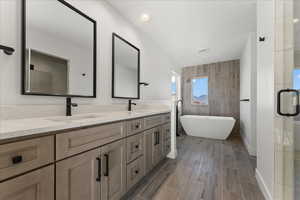 Bathroom with tile walls and double vanity