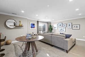 Carpeted living room with crown molding