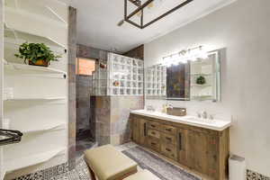 Master Bathroom featuring a tile shower and dual bowl vanity