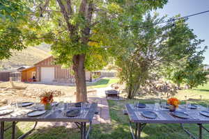 View of yard featuring an outdoor fire pit, a garage, and a patio