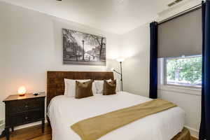 Bedroom featuring dark wood-type flooring