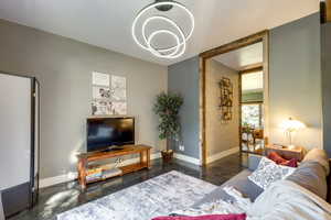 Living room featuring dark hardwood / wood-style floors and a chandelier