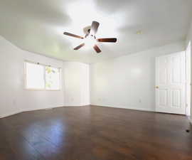 Unfurnished room featuring ceiling fan and dark hardwood / wood-style flooring