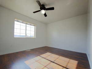 Unfurnished room with ceiling fan and hardwood / wood-style flooring