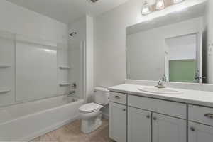 Full bathroom featuring tile floors, shower / bathtub combination, toilet, and vanity