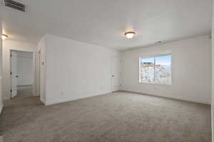 Empty room featuring carpet flooring