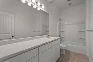 Full bathroom featuring tile floors, shower / washtub combination, toilet, and large vanity