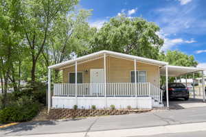 Manufactured / mobile home with covered porch and a carport