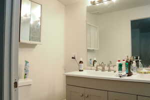 Bathroom featuring oversized vanity and toilet