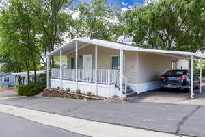 Manufactured / mobile home with a carport and a porch