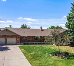 View of front of house featuring a garage and a front yard