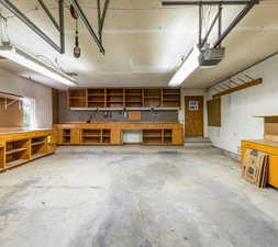 Garage featuring a workshop area and a garage door opener