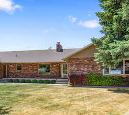 Ranch-style house with a front lawn