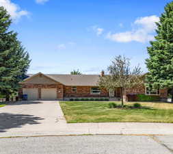 Ranch-style house with a garage and a front yard