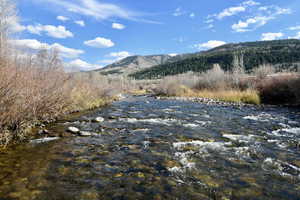 Property view of mountains with a water view