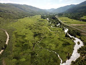 Birds eye view of property with a rural view and a mountain view